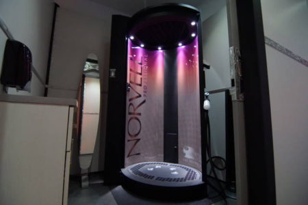 A large shower with lights on the side of it.
