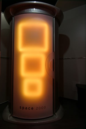 A large orange light is on in the middle of a room.