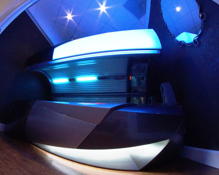 A futuristic looking bed with lights on the top.