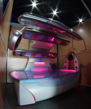 A futuristic looking bed with lights on the top.