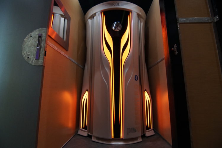 A futuristic looking elevator with yellow lights on it.