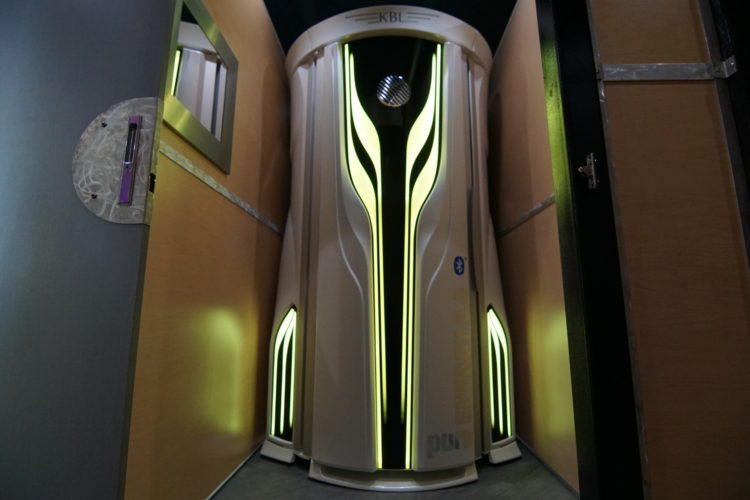 A futuristic looking elevator with yellow lights on it.