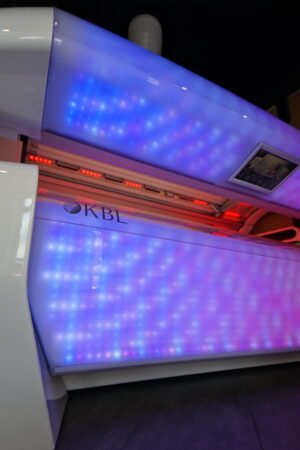 A tanning bed with blue lights on it.