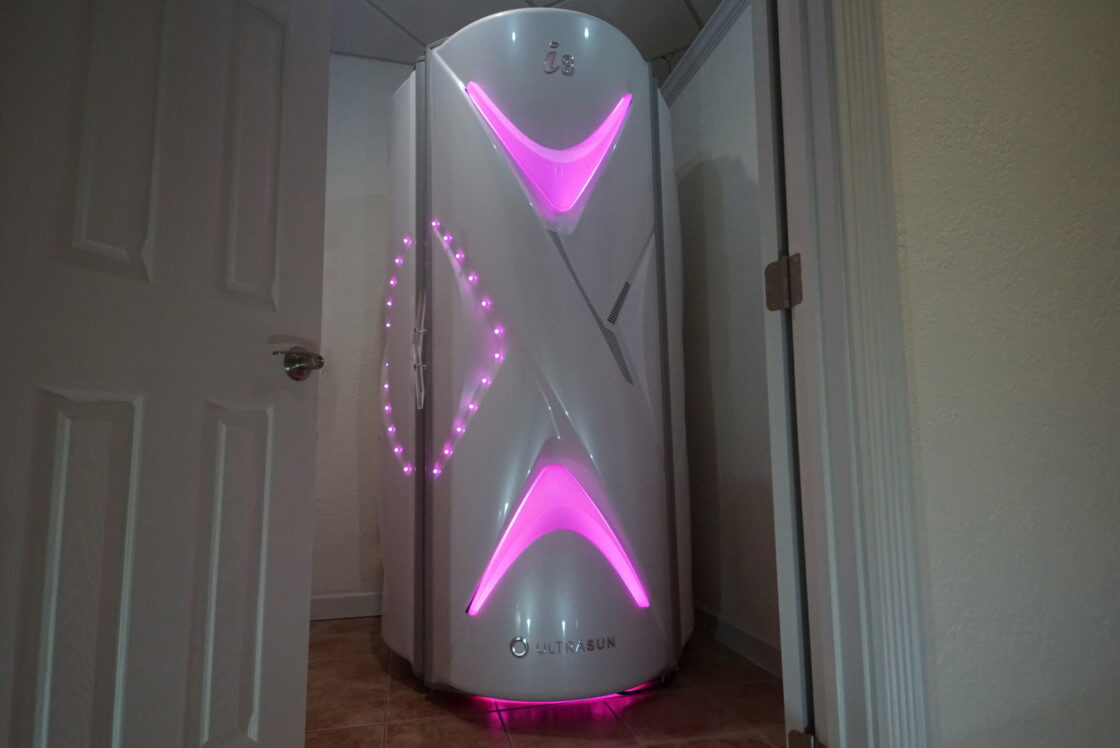 A white and pink light up machine in the corner of room.