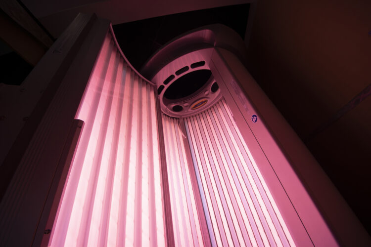 A pink light is on in the corner of a room.