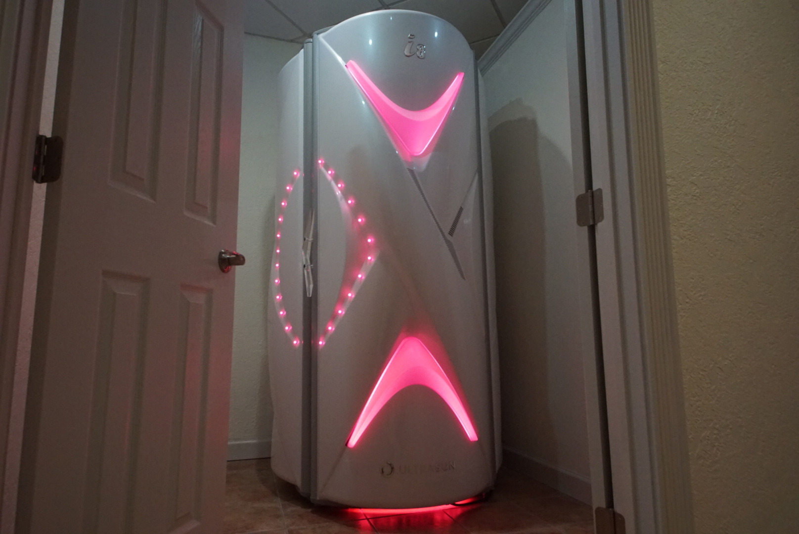 A white and red light up machine in the corner of room.