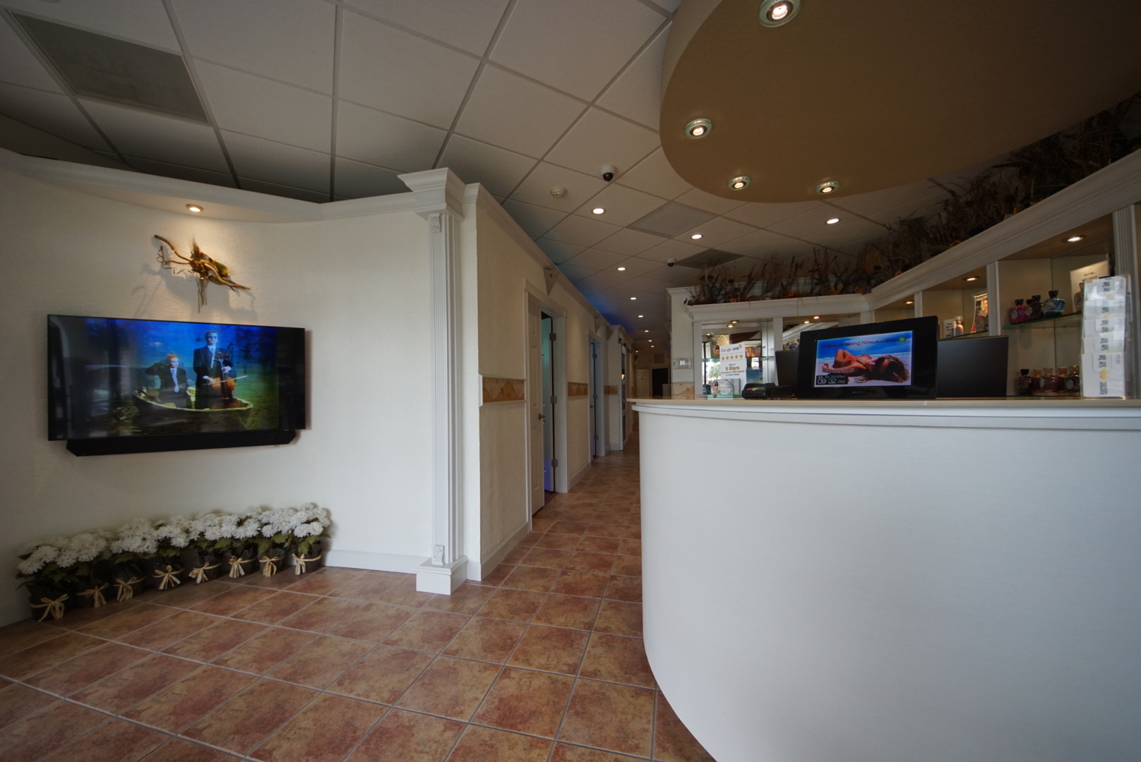 A large white reception area with a television on the wall.